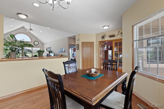 5726 Wolf Creek Hwy, Adrian, MI 49221 - dining space featuring light wood-type flooring, lofted ceiling, ceiling fan, and a chandelier