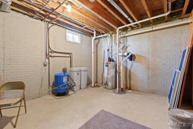 5726 Wolf Creek Hwy, Adrian, MI 49221 - below grade area with a water pressure tank, a water softener system, gas water heater, and brick wall