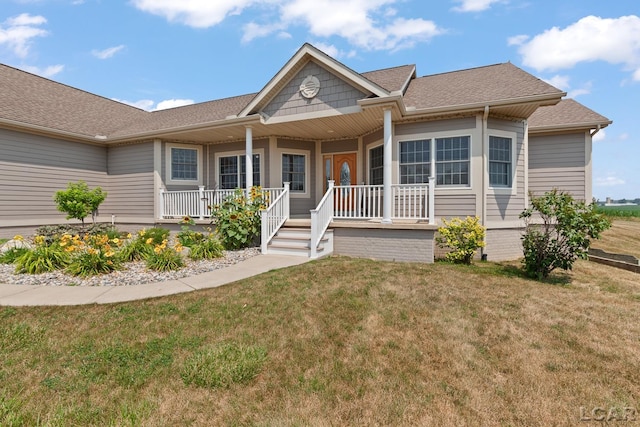 5726 Wolf Creek Hwy, Adrian, MI 49221 - ranch-style home with a shingled roof, covered porch, and a front yard