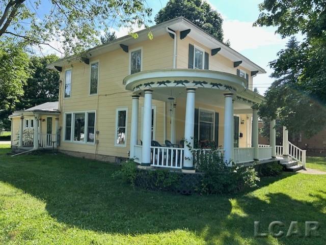 114 E Pottawatamie St, Tecumseh, MI 49286 - back of property featuring a porch and a yard