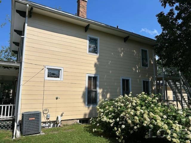 114 E Pottawatamie St, Tecumseh, MI 49286 - rear view of house with a chimney and stairs
