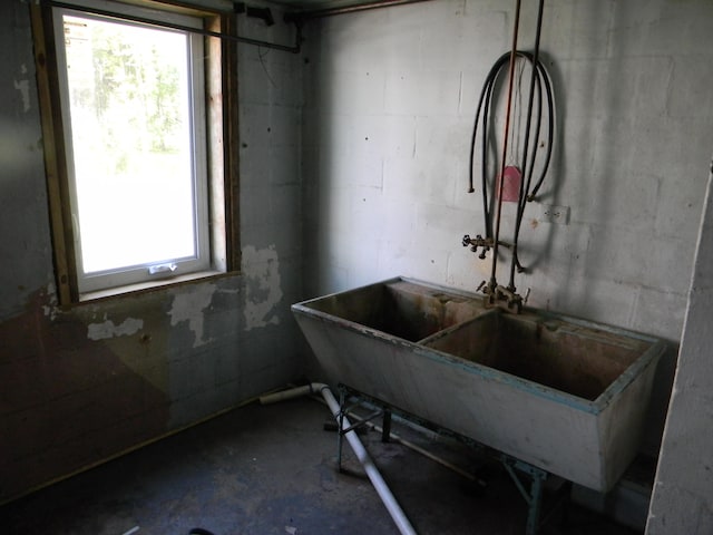 misc room featuring concrete flooring, plenty of natural light, and sink