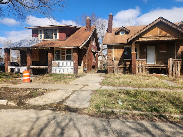 3226 Columbus St, Detroit, MI 48206 - view of front of property featuring covered porch and a chimney