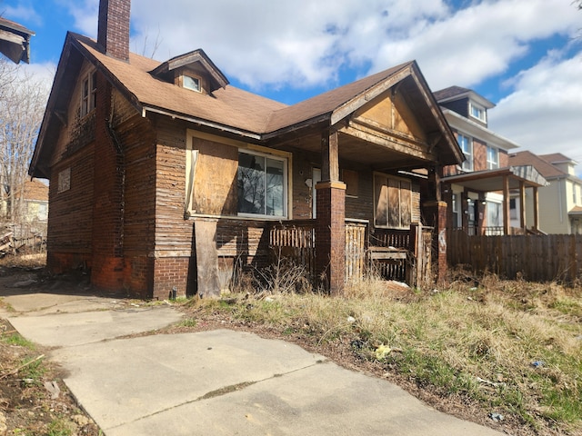3226 Columbus St, Detroit, MI 48206 - view of home's exterior featuring a chimney and covered porch