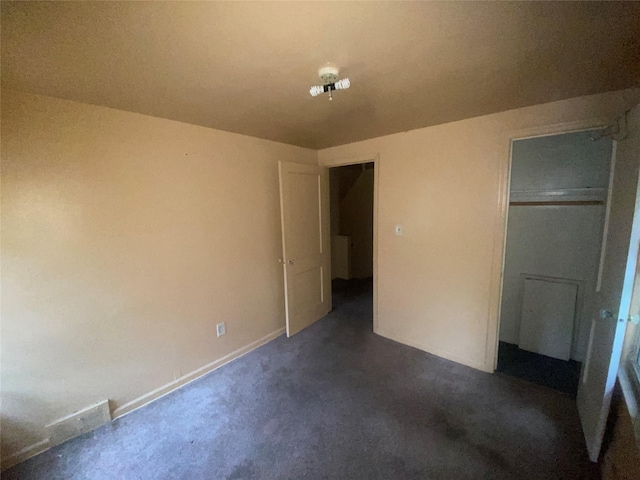 18905 Evergreen Rd, Detroit, MI 48219 - unfurnished bedroom featuring dark carpet, baseboards, and a closet