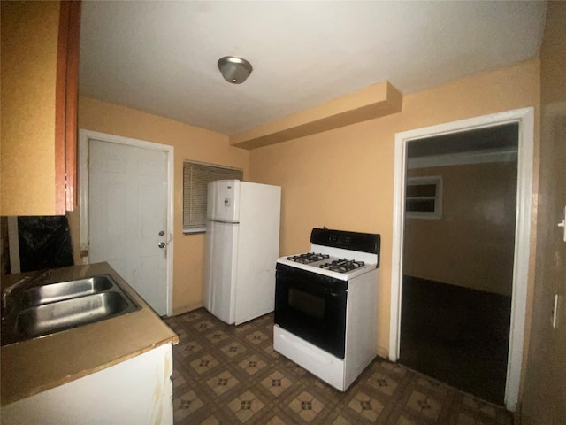 18905 Evergreen Rd, Detroit, MI 48219 - kitchen with range with gas cooktop, freestanding refrigerator, a sink, and tile patterned floors
