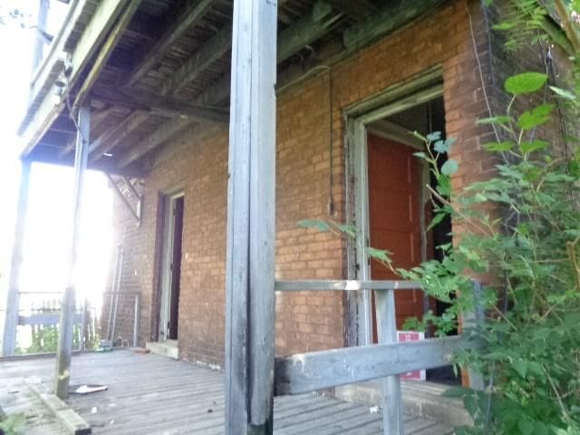 view of property exterior with a wooden deck