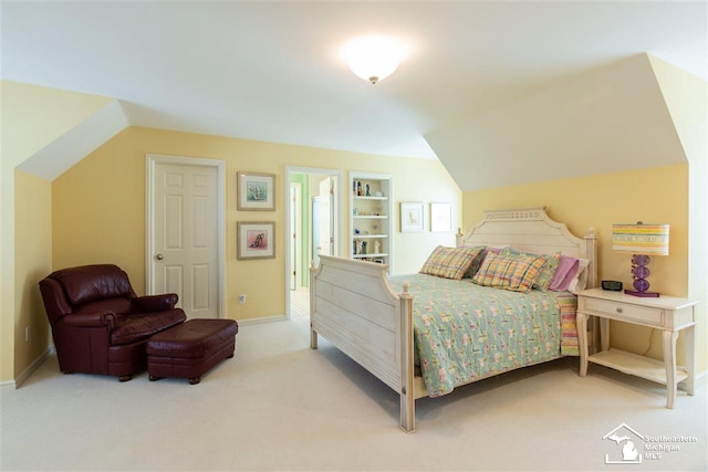 bedroom featuring carpet and vaulted ceiling