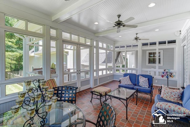 sunroom with ceiling fan, beam ceiling, and a wealth of natural light