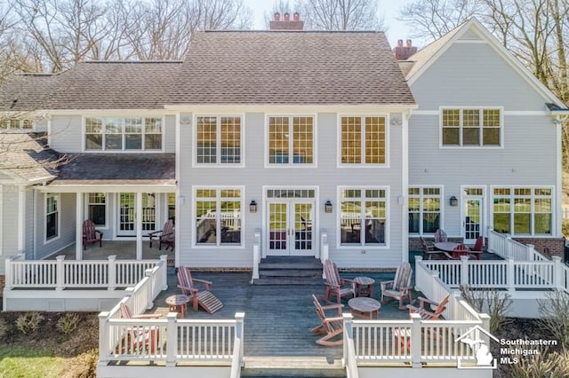 rear view of house featuring french doors and a wooden deck