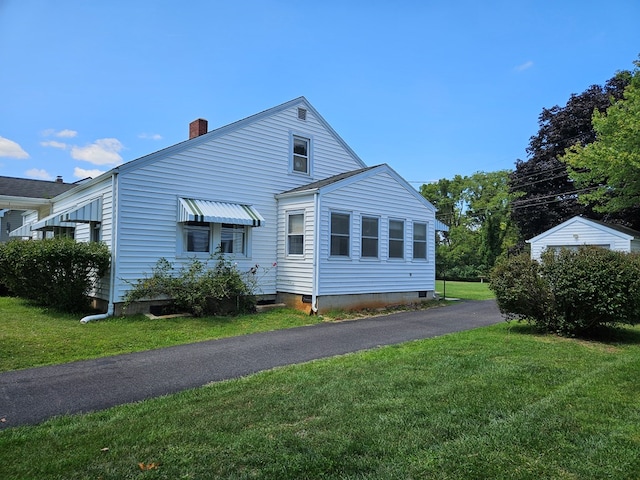 rear view of house with a lawn