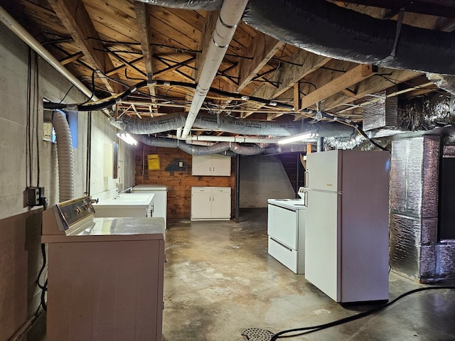 basement featuring white fridge and separate washer and dryer