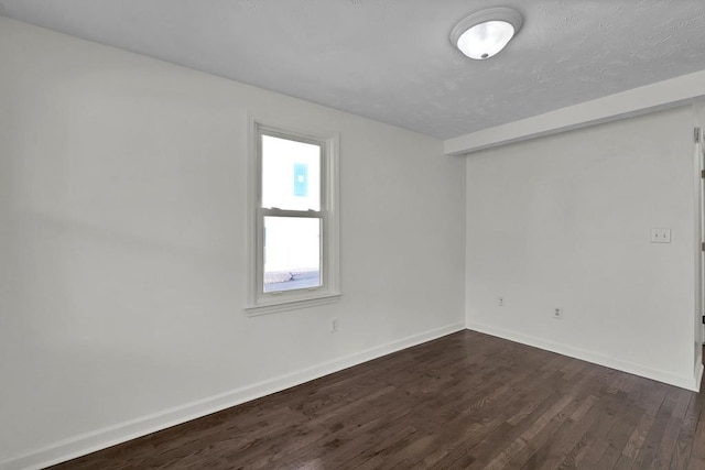 spare room featuring dark hardwood / wood-style floors