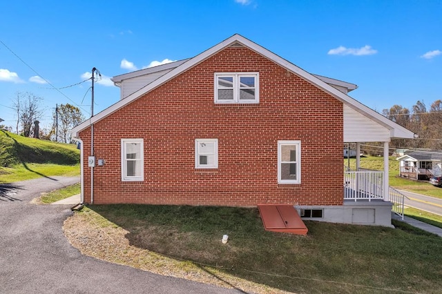 view of side of home with a lawn