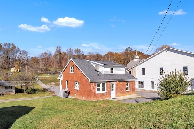 back of house with a lawn