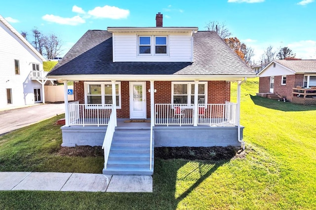 bungalow-style home with a front yard and covered porch