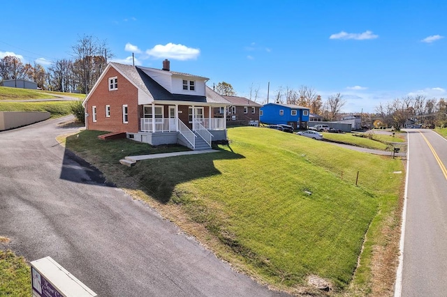 view of front of house with a porch and a front lawn