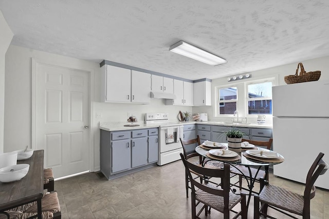 kitchen with sink, white appliances, gray cabinetry, a textured ceiling, and white cabinets