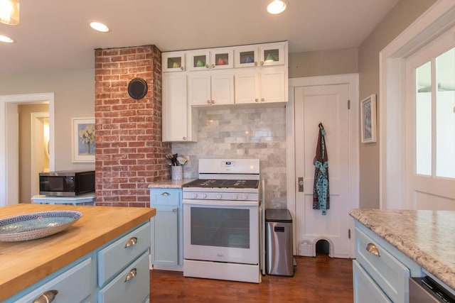 kitchen with white cabinets, blue cabinets, stainless steel microwave, butcher block countertops, and white range with gas stovetop