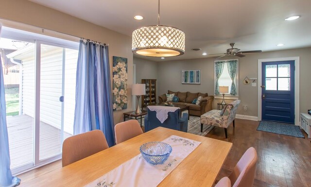 dining space with baseboards, a ceiling fan, wood finished floors, and recessed lighting