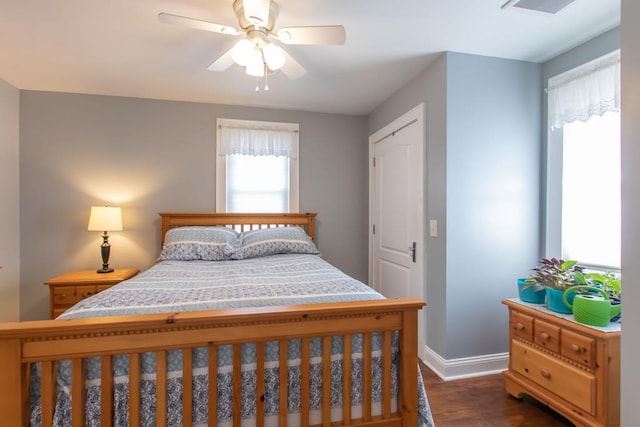 bedroom featuring ceiling fan, baseboards, dark wood-type flooring, and visible vents