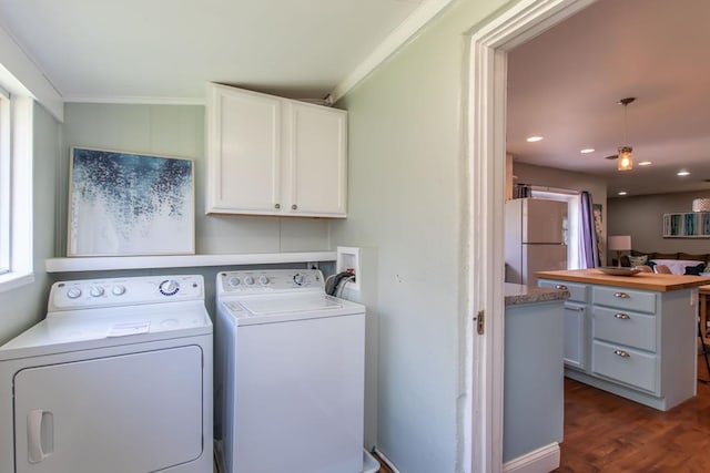 washroom with washing machine and clothes dryer, cabinet space, dark wood finished floors, ornamental molding, and recessed lighting