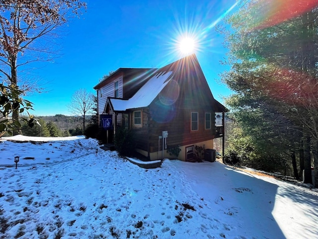 snow covered property featuring cooling unit