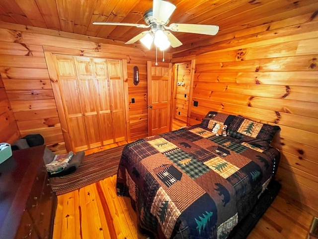 bedroom featuring hardwood / wood-style floors, wooden ceiling, and ceiling fan