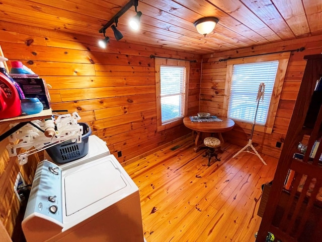 clothes washing area featuring wood ceiling, rail lighting, hardwood / wood-style flooring, and wood walls