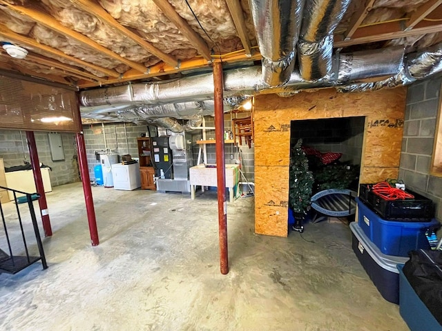 basement with heating unit and washing machine and dryer