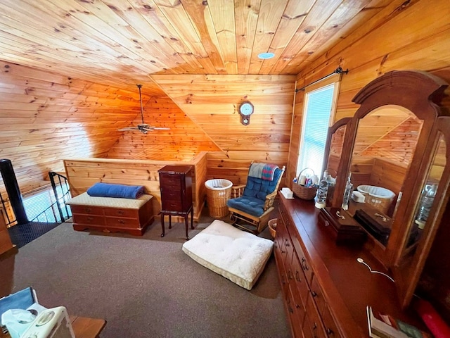 carpeted bedroom with wood walls and wooden ceiling