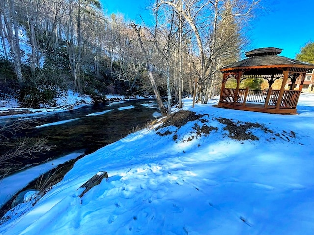 yard covered in snow with a gazebo