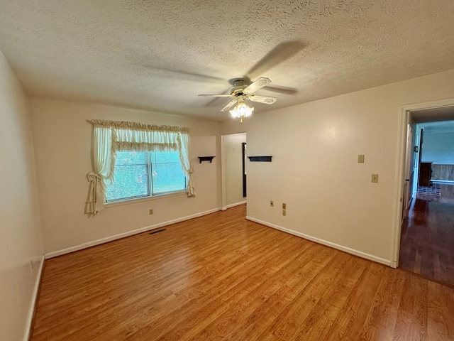 15296 Blueberry Ln, Chilhowie, VA 24319 - spare room featuring wood finished floors, ceiling fan, a textured ceiling, and baseboards