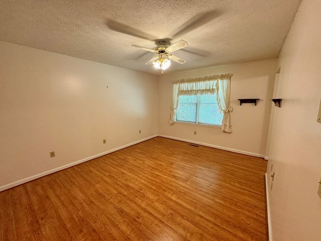 15296 Blueberry Ln, Chilhowie, VA 24319 - unfurnished room featuring wood finished floors, a ceiling fan, baseboards, and a textured ceiling