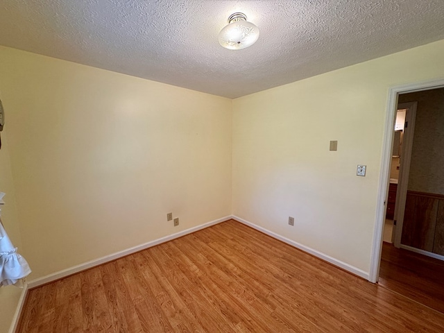 15296 Blueberry Ln, Chilhowie, VA 24319 - unfurnished room featuring light wood finished floors, a textured ceiling, and baseboards