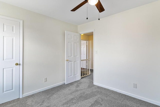 unfurnished bedroom featuring baseboards, ceiling fan, and carpet flooring