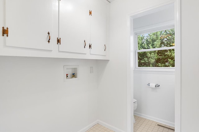 clothes washing area featuring baseboards, visible vents, cabinet space, and hookup for a washing machine