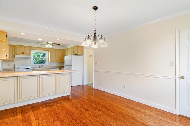 kitchen with crown molding, light countertops, a sink, light wood-type flooring, and white appliances