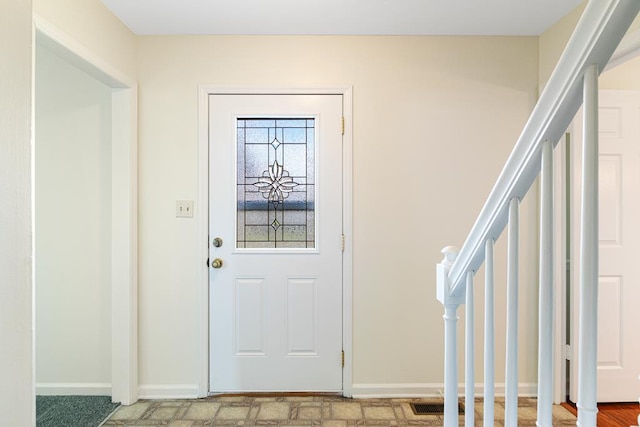 entrance foyer featuring stairs, visible vents, and baseboards