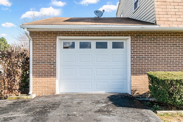 garage with aphalt driveway