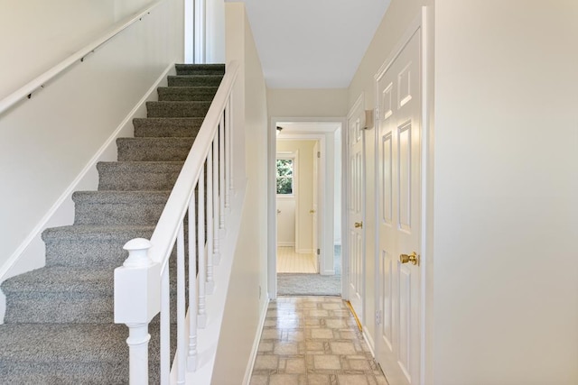 stairs with stone finish flooring and baseboards