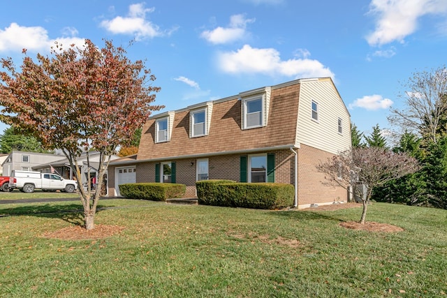 view of front facade with a front lawn, a gambrel roof, an attached garage, and brick siding
