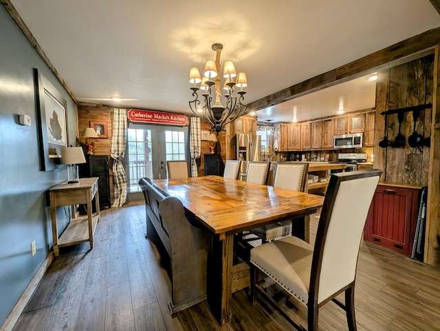 dining area featuring beam ceiling, french doors, a notable chandelier, and dark wood-style flooring