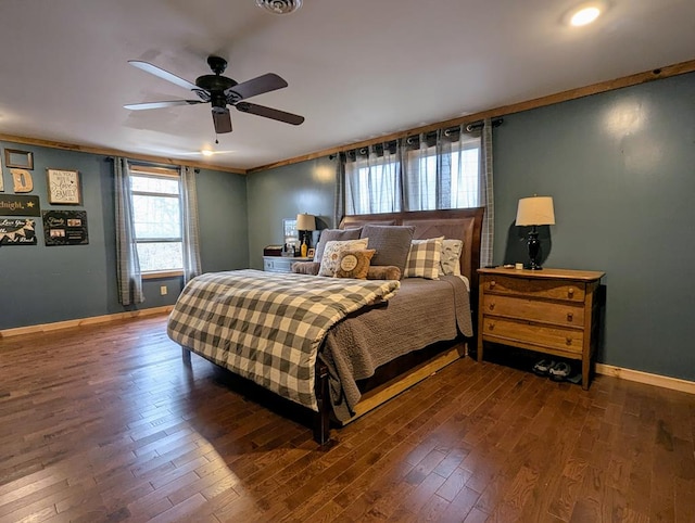 bedroom with visible vents, baseboards, ceiling fan, ornamental molding, and wood finished floors