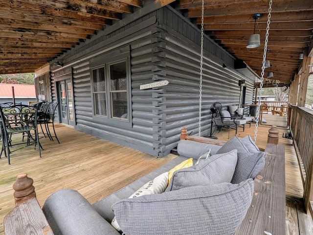 wooden terrace featuring outdoor dining area