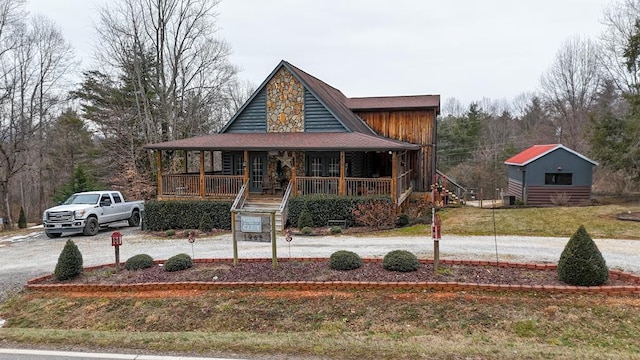 view of front facade featuring covered porch, stairs, and a front lawn