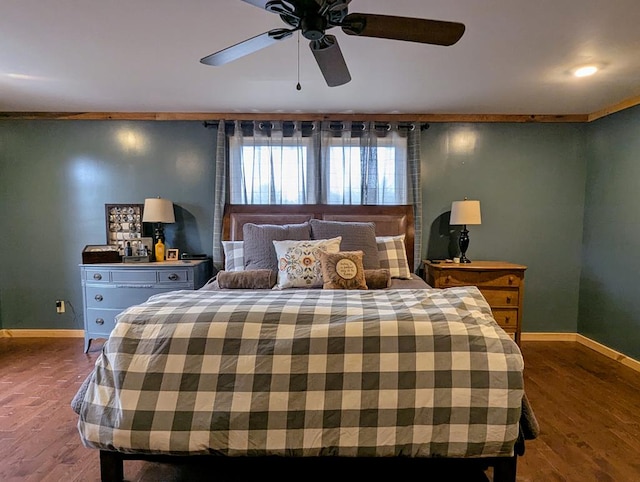 bedroom with wood finished floors, a ceiling fan, and baseboards