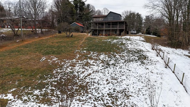 yard covered in snow featuring a wooden deck