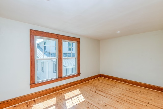 empty room with recessed lighting, baseboards, and hardwood / wood-style floors