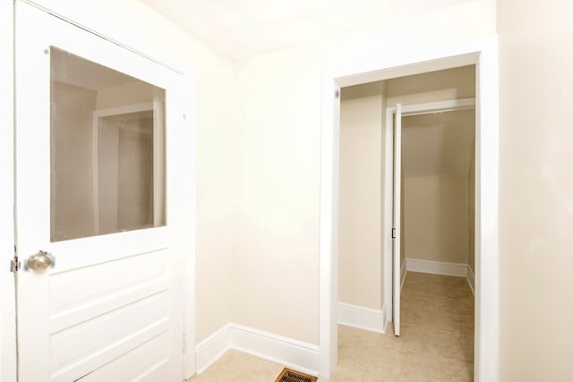 corridor with visible vents and baseboards